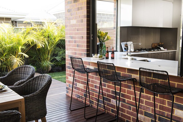 Make use of all the space available; a balustrade breakfast bar facing out into the garden is a great option.